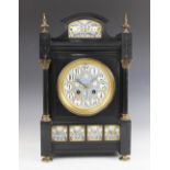 A late 19th century Aesthetic movement slate mantel clock, the architectural case with