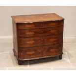 An early 18th century walnut and marquetry chest of drawers, the bow front moulded top inlaid with a