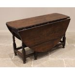 An 18th century oak gateleg dining table, the oval top above a single frieze drawer, raised upon