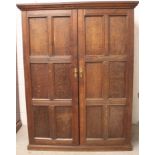 An 18th century and later constructed panelled hall/livery cupboard, designed with two full-height