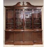 A 19th century and later mahogany breakfront library bookcase, with broken swan's neck pediment