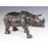 An Abercrombie & Fitch type leather model of a Rhinoceros, 20th century, 51cm long