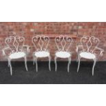 A set of four French painted wrought iron bistro/patio chairs, mid 20th century, each with a