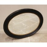 A 19th century style ebonised oval wall mirror, late 20th/early 21st century, the bevelled