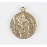 A gold coloured St Christopher double sided pendant, of circular form, one side depicting St