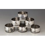 A collection of six Iraqi niello type white metal napkin rings, decorated with river landscape