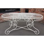 A 19th century painted wrought iron patio/garden table, possibly French, the oval top formed from