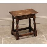 An 18th century style oak joint stool, late 19th century, the rectangular moulded top above a carved