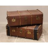 A near pair of ribbed canvas travel trunks, early 20th century, each applied with leather side