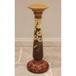 An early 20th century glazed earthenware jardinere stand in the manner of Minton, the circular