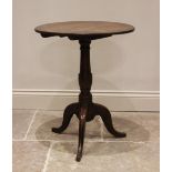 A George III oak tripod table, the circular top raised upon a ring turned and cup tapering column