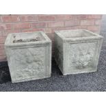 A pair of reconstituted planters, of cubic form, each moulded in relief with foliate and fruit