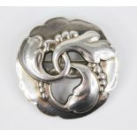 Georg Jensen, a silver brooch, circular form with shaped border, pierced entwined foliate design,