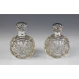 A pair of Edwardian silver mounted glass dressing table jars, London 1906, of typical spherical form
