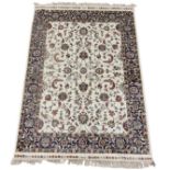 An ivory ground Kashmir rug, with all over scrolling floral design enclosed within a repeating