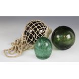 A Victorian glass dump paperweight, 11cm high, with a olive green glass water buoy and a further