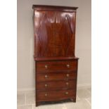 A late George III mahogany secretaire bookcase, the moulded cornice over a pair of segmentally