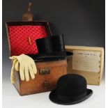 A silk top hat by Austin Reed, Regent Street, to a fitted leather hat box, applied with the initials