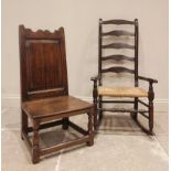 An 18th century oak low seat chair, the panelled back above a board seat, raised upon front baluster