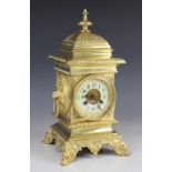 A late 19th century French gilt metal cubic mantel clock, the case of architectural form cast with