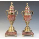 A pair of 19th century style rouge marble and gilt metal mounted urns, each of baluster form with