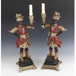 A pair of composite figural candlesticks, late 20th century, each blackamoor modelled wearing