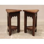 A pair of 17th century style oak lamp tables, late 20th century, each with a hinged triangular top