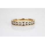 A diamond half eternity 9ct gold ring, comprising eleven round brilliant cut diamonds, each weighing