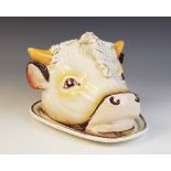An early 20th century glazed earthenware tongue or cheese dish, modelled in the form of a bulls head