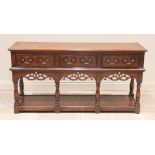 A George III style oak dresser base in the manner of Titchmarsh and Goodwin, late 20th century,