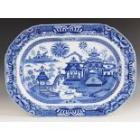 An English blue and white meat plate, 19th century, of large oval form decorated with pagodas,