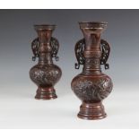 A pair of Japanese bronze vases, 20th century, each of bulbous baluster form with reticulated lug