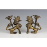 A pair of Chinese brass candlesticks, 20th century, each modelled as a seated mythical beast, 9cm