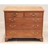 A George III oak chest of drawers, the rectangular moulded top over an arrangement of two short