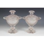 A pair of Victorian cut glass comports and covers, each of pedestal form and raised upon a petal cut