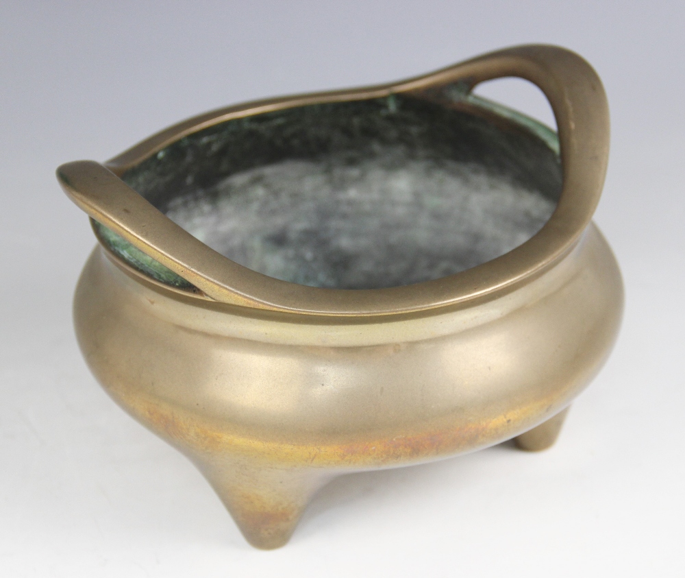 A Chinese polished bronze censer, Xuande mark, of typical plain circular form raised on three legs - Image 2 of 15