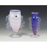 Two John Foster (contemporary British) studio glass fish vases, one in pale pink with white bands on
