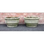 A pair of reconstituted stone planters, of bowl form, cast with ribbed detail, 30cm H x 55cm D