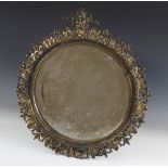 A circular brass wall mirror, 19th century, bearing 'Reg 38907' stamp verso, the circular frame
