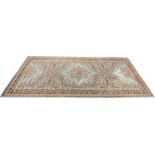 A large wool pile Wilton carpet, the central foliate Persian style medallion upon a sage green