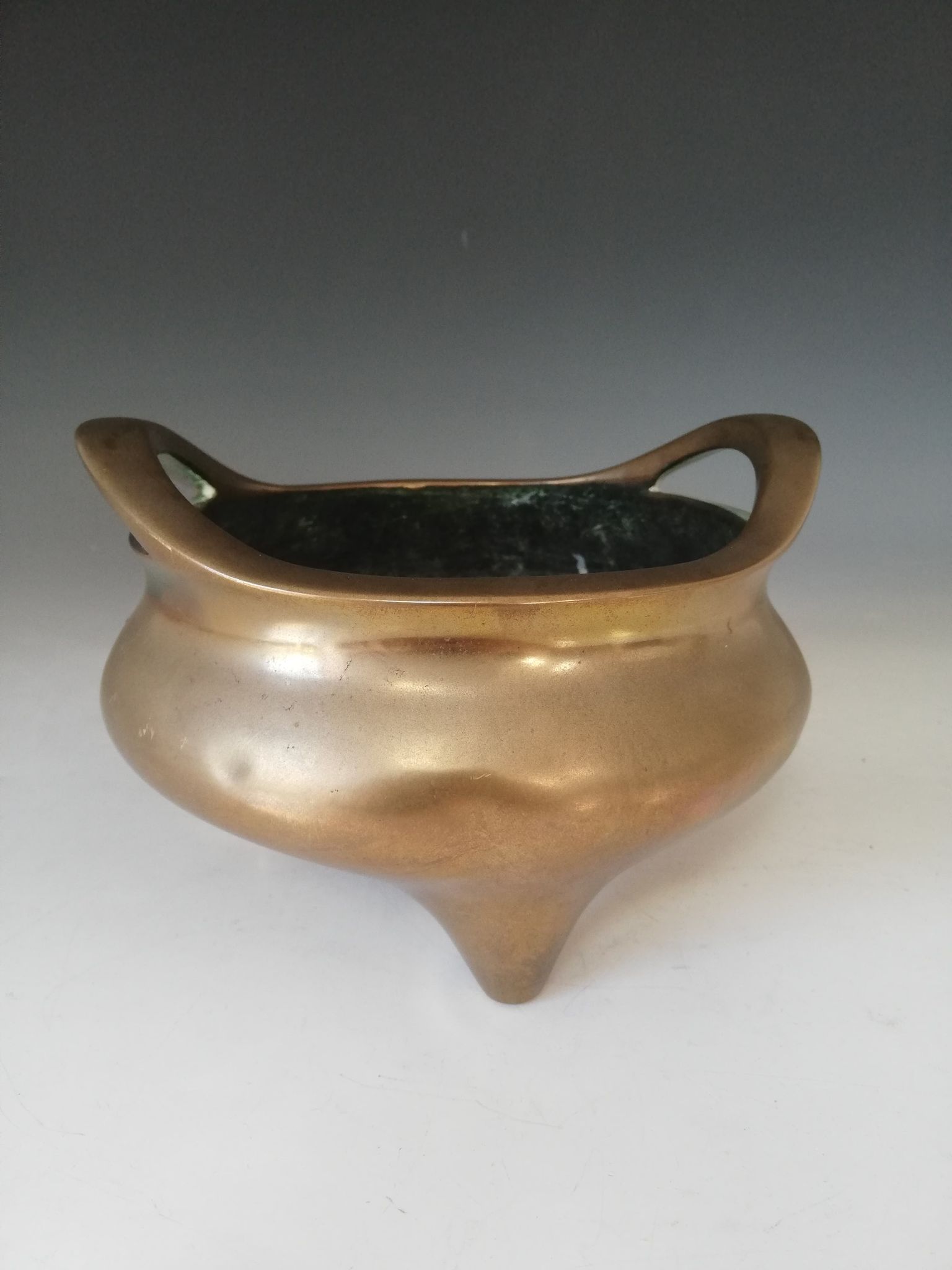 A Chinese polished bronze censer, Xuande mark, of typical plain circular form raised on three legs - Image 10 of 15