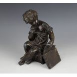 A bronze patinated spelter figure, 20th century, modelled as a seated child pulling papers from a