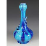 A drip glazed pottery bottle vase, possibly Burmantofts, externally glazed in tones of blue and