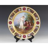 A late 19th century continental porcelain painted charger, the centre depicting a sleeping Mars