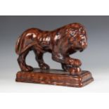A treacle-ware sponge glazed model of a lion, late 19th century, modelled standing upon a
