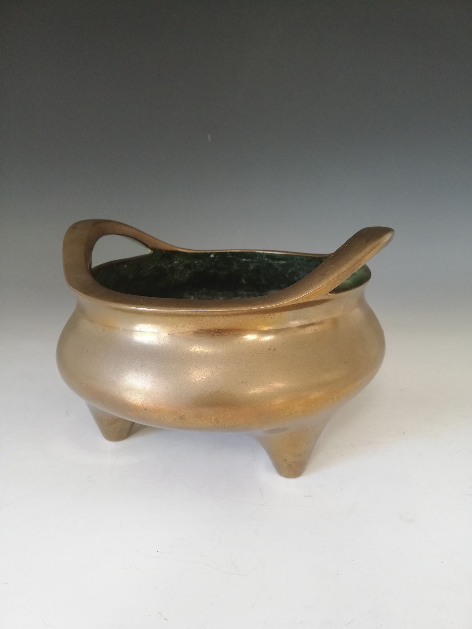 A Chinese polished bronze censer, Xuande mark, of typical plain circular form raised on three legs - Image 14 of 15