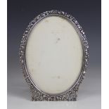 A Dutch silver mounted photograph frame, of oval form with pierced foliate, fruit and foliate