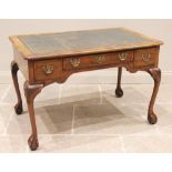 A George II style figured walnut writing/library desk, early 20th century, the rectangular moulded
