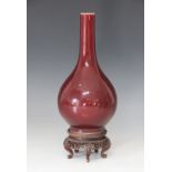 A Chinese porcelain sang de boeuf flambe bottle vase, 19th century, recessed base, 22.5cm high,