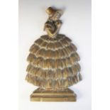 A Victorian cast brass door porter, modelled as a lady wearing a bonnet and dress, holding a bouquet